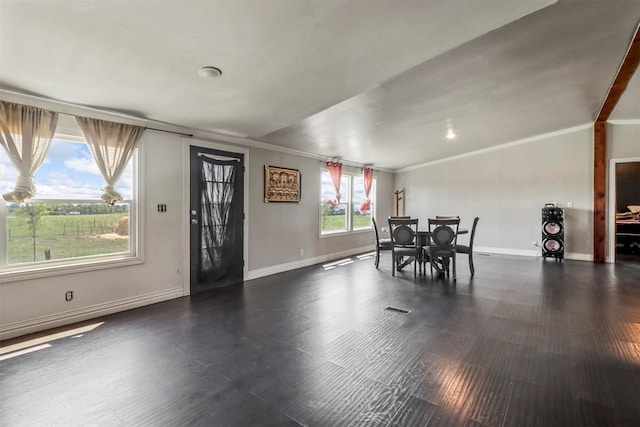 interior space featuring wood-type flooring, ornamental molding, and lofted ceiling