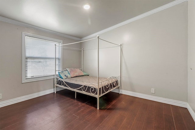 bedroom featuring hardwood / wood-style flooring and crown molding