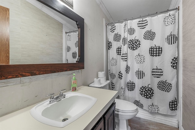 bathroom featuring toilet, vanity, walk in shower, hardwood / wood-style flooring, and crown molding