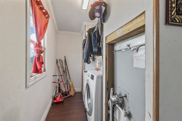 laundry room with washing machine and dryer, dark hardwood / wood-style floors, and ornamental molding