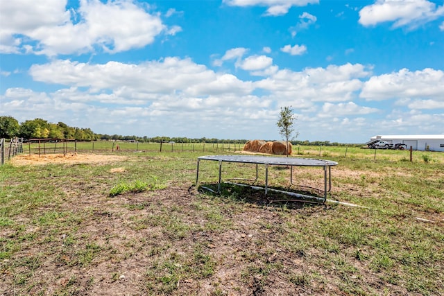 surrounding community featuring a rural view and a trampoline