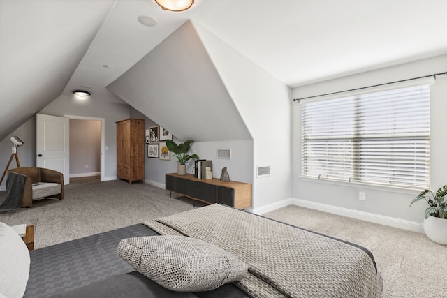 carpeted bedroom featuring vaulted ceiling