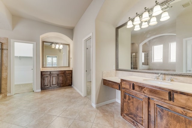 bathroom with vanity, a shower with shower door, and tile patterned floors