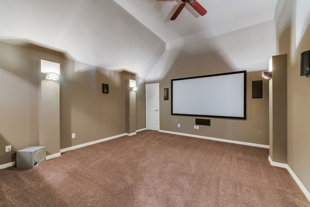 carpeted cinema room featuring ceiling fan and vaulted ceiling