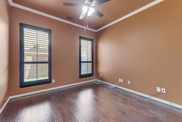 spare room with wood-type flooring, a wealth of natural light, and crown molding