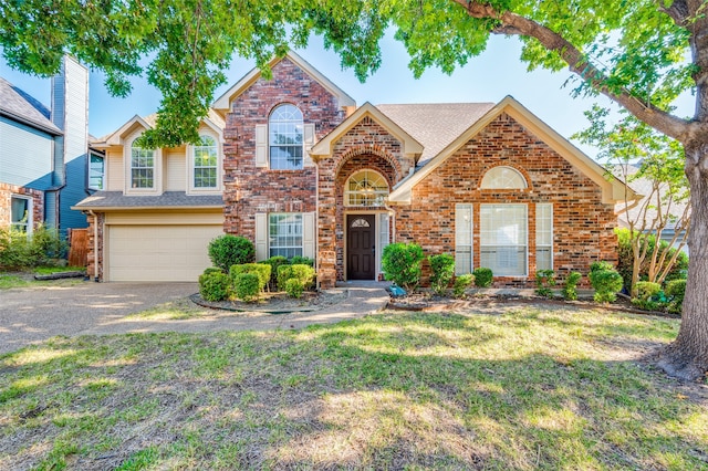 front of property featuring a front lawn and a garage