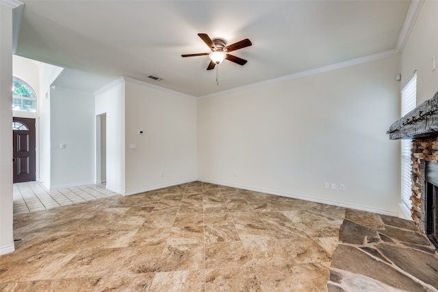 unfurnished living room featuring light tile patterned floors, ceiling fan, ornamental molding, and a stone fireplace