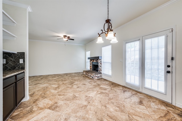 unfurnished living room with crown molding, ceiling fan, light tile patterned floors, and a fireplace