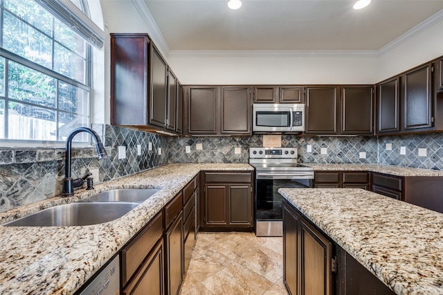 kitchen featuring backsplash, appliances with stainless steel finishes, sink, a healthy amount of sunlight, and light tile patterned flooring