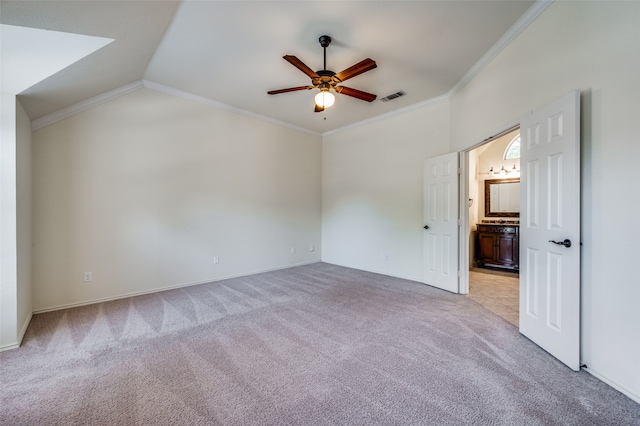 unfurnished bedroom with lofted ceiling, light colored carpet, ornamental molding, and ceiling fan