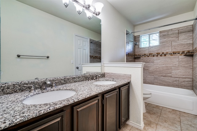 full bathroom featuring tile patterned flooring, vanity, toilet, and tiled shower / bath