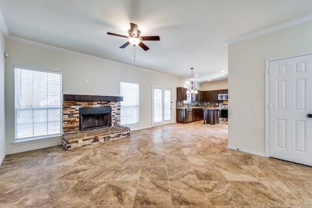 tiled living room featuring ceiling fan with notable chandelier, a fireplace, and ornamental molding