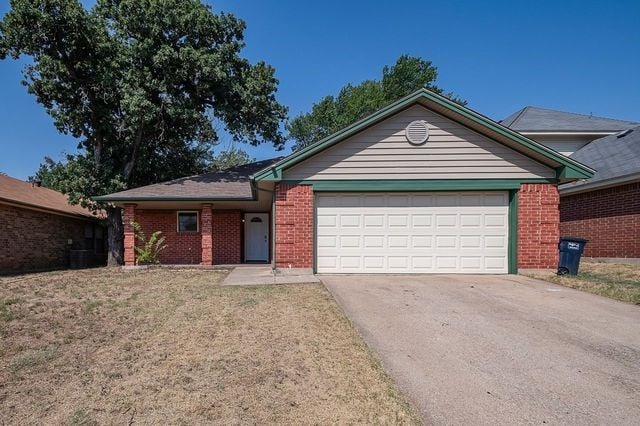 ranch-style home featuring a garage