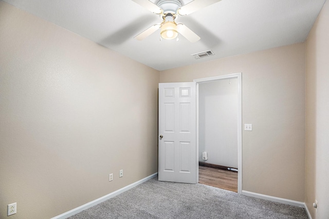 unfurnished bedroom with ceiling fan and light carpet