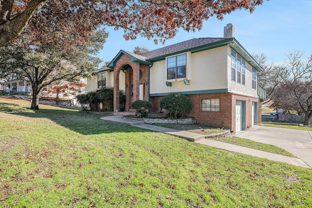 view of front of property with a front yard and a garage