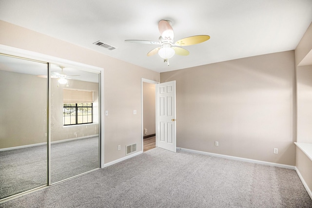 unfurnished bedroom featuring carpet floors, ceiling fan, and a closet