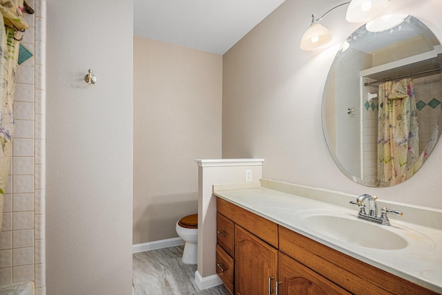 bathroom with wood-type flooring, vanity, toilet, and curtained shower