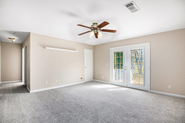 empty room with french doors, ceiling fan, and carpet floors