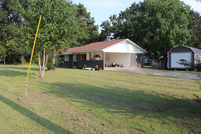 ranch-style house with a garage, a front lawn, and an outdoor structure