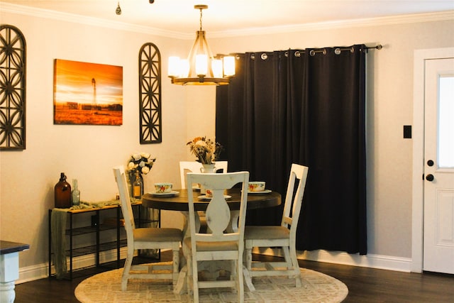 dining space featuring crown molding, dark wood-type flooring, and a chandelier