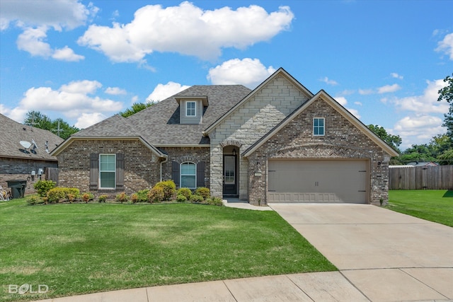 view of front of home featuring a garage and a front lawn