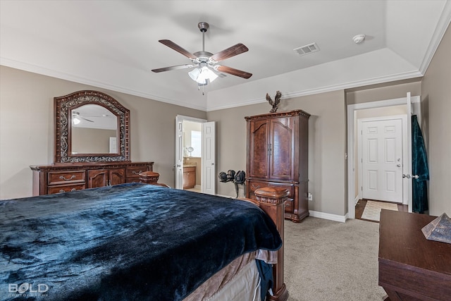 carpeted bedroom featuring ceiling fan, a raised ceiling, crown molding, and ensuite bath