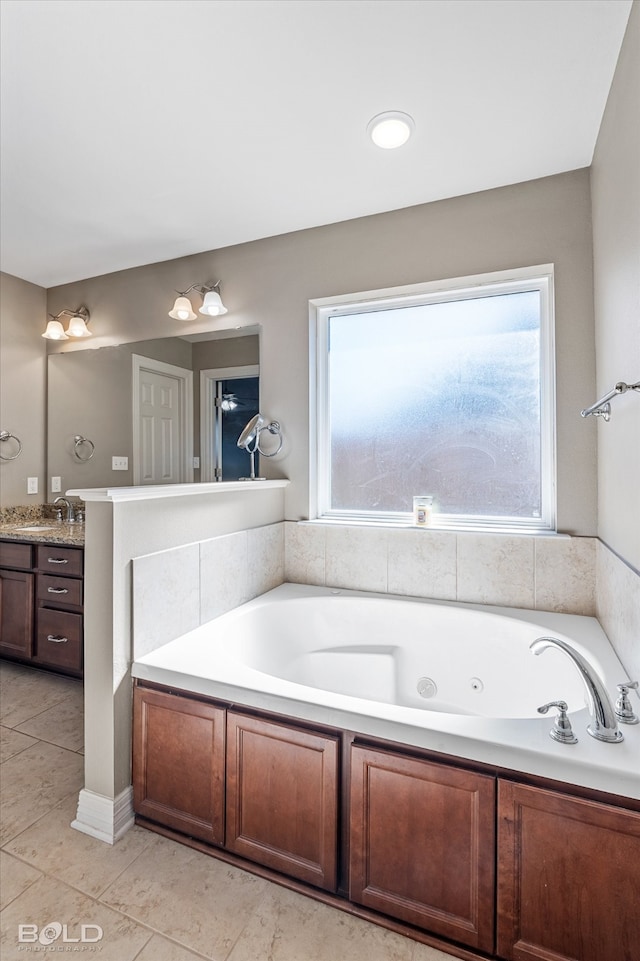 bathroom featuring tile patterned flooring, a tub, and vanity