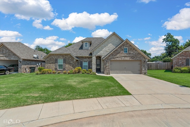 view of front of property with a garage and a front lawn