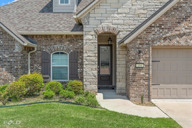 view of exterior entry with a lawn