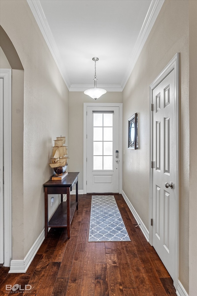 doorway to outside with ornamental molding and dark hardwood / wood-style flooring