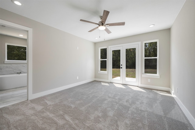 unfurnished room featuring light carpet, french doors, and ceiling fan