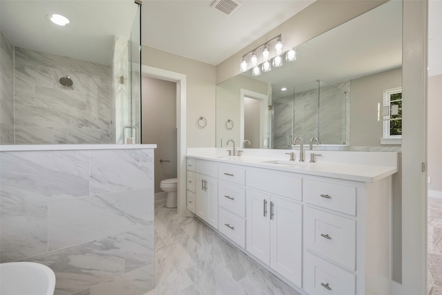 bathroom with vanity, toilet, and an enclosed shower