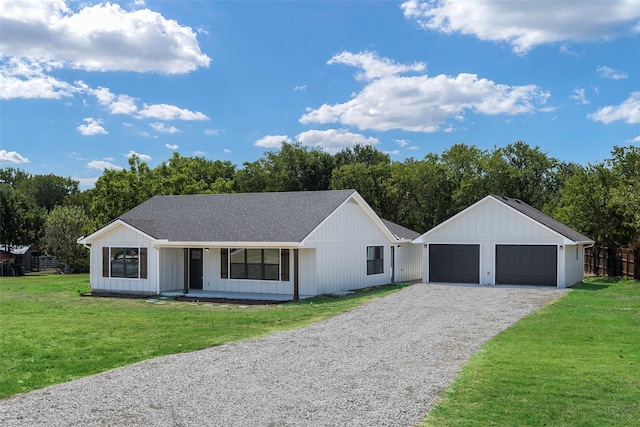 view of front of home featuring a garage, a front yard, and a porch