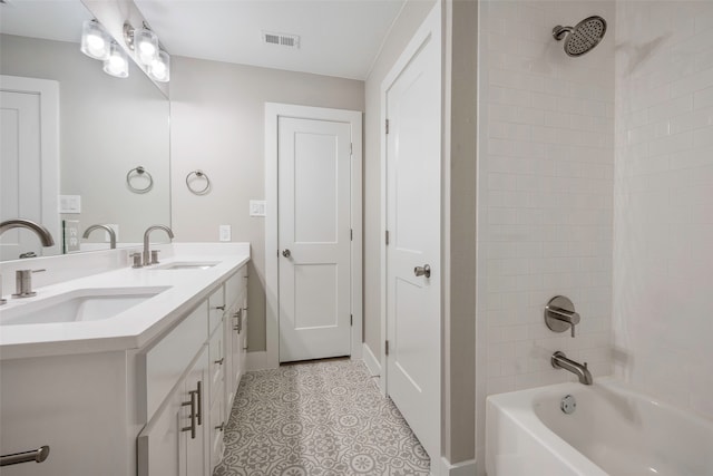 bathroom with vanity and tiled shower / bath combo