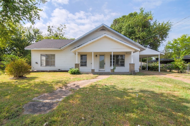 view of front of house featuring a front yard, a carport, and covered porch