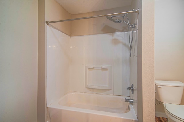 bathroom featuring bathtub / shower combination and toilet