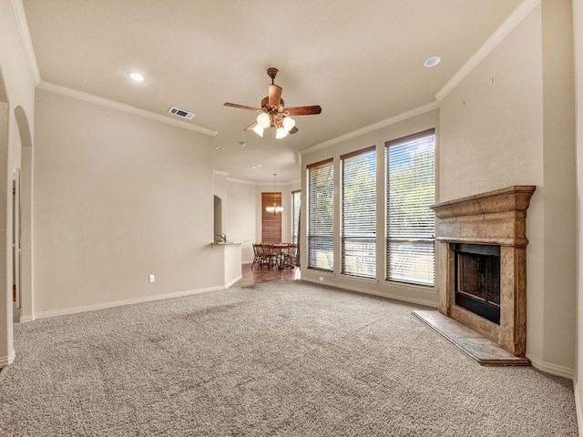 unfurnished living room featuring baseboards, visible vents, a premium fireplace, carpet floors, and ceiling fan with notable chandelier