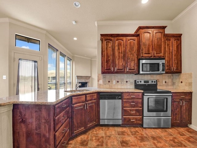 kitchen featuring crown molding, appliances with stainless steel finishes, backsplash, and a sink