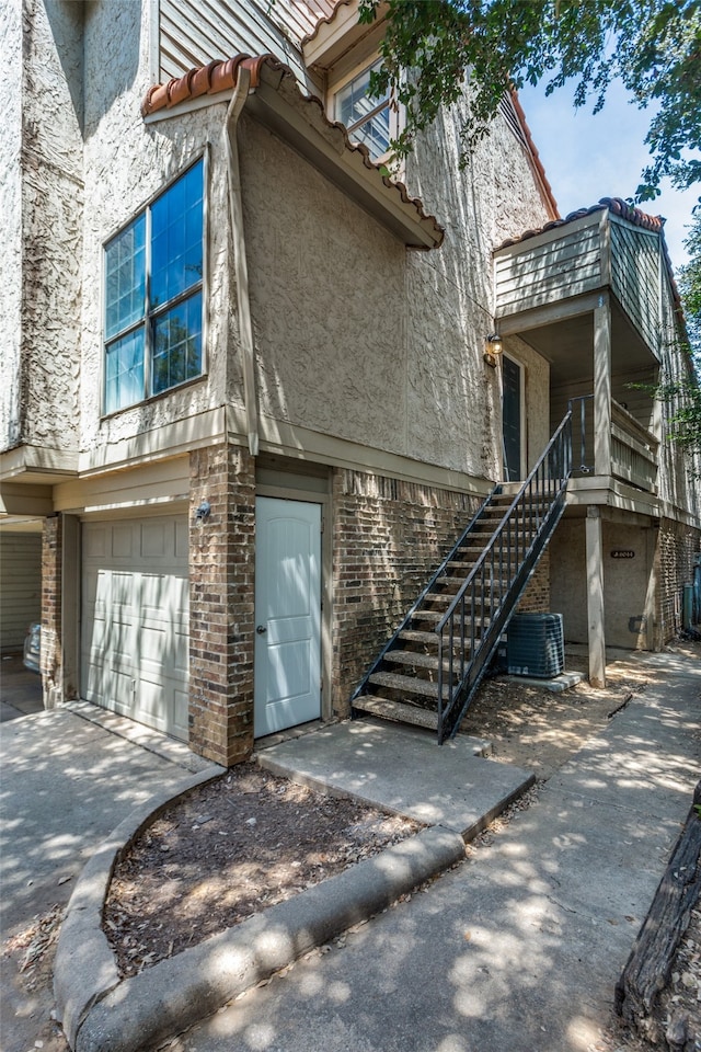 view of home's exterior featuring central AC and a garage