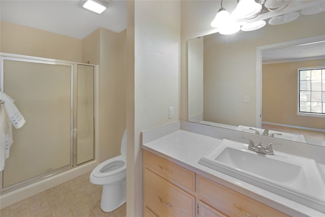 bathroom featuring tile patterned floors, vanity, walk in shower, and toilet