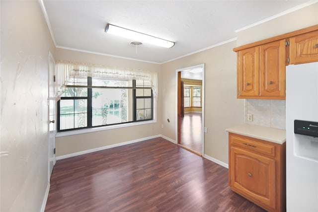 kitchen with white fridge with ice dispenser, ornamental molding, decorative backsplash, and dark hardwood / wood-style flooring