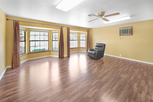 unfurnished room with ceiling fan, dark hardwood / wood-style floors, plenty of natural light, and an AC wall unit