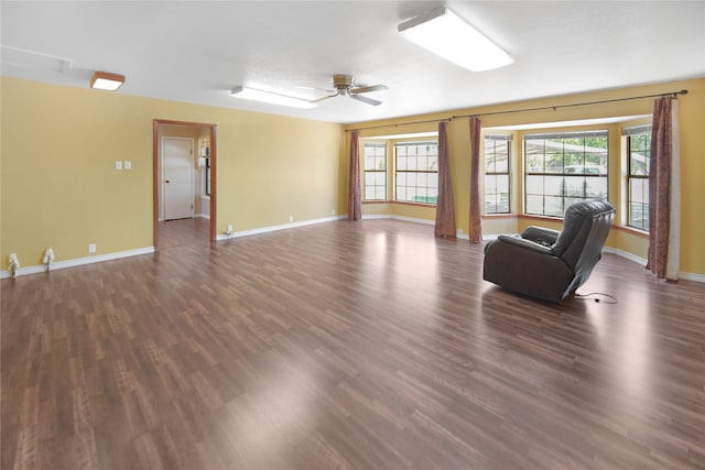 unfurnished living room featuring ceiling fan and wood-type flooring