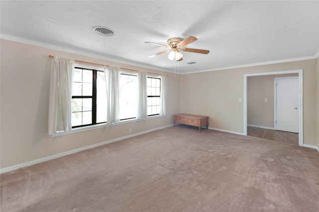 unfurnished room with ceiling fan, crown molding, and carpet flooring