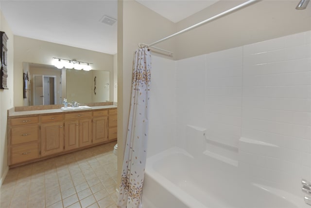 bathroom featuring tile patterned flooring, vanity, and shower / bath combo