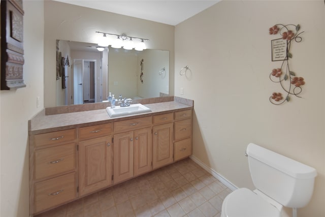 bathroom featuring tile patterned floors, vanity, and toilet