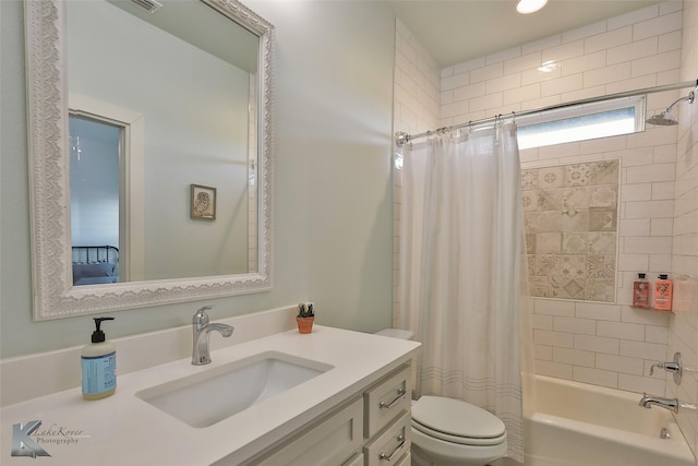 full bathroom featuring shower / bathtub combination with curtain, toilet, and vanity