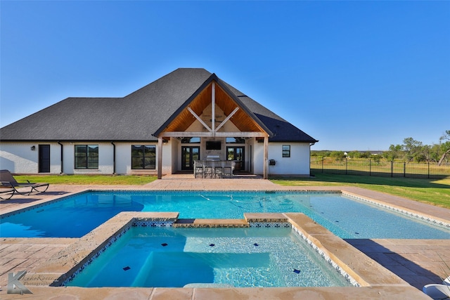 view of swimming pool featuring outdoor dry bar, a patio, fence, and a pool with connected hot tub