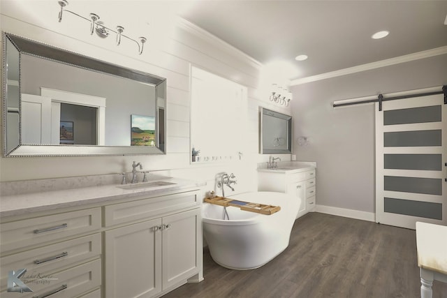 full bathroom featuring ornamental molding, wood finished floors, a sink, a freestanding tub, and two vanities