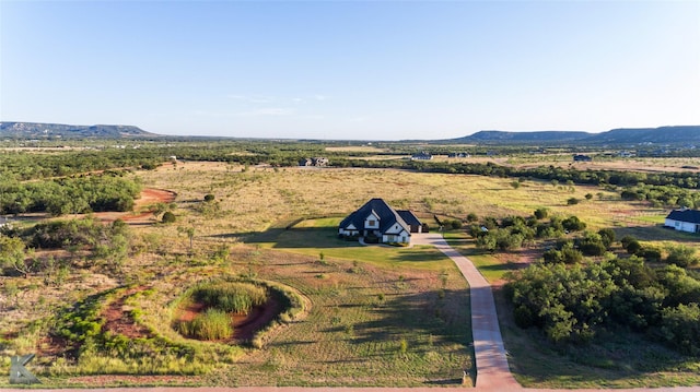 drone / aerial view featuring a rural view and a mountain view